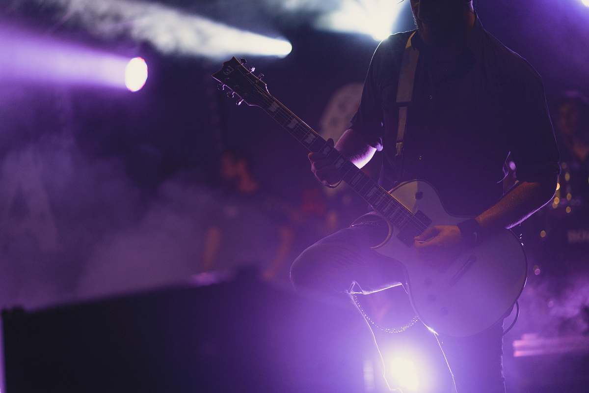 leisure activities man wearing black dress shirt performing stage musical instrument